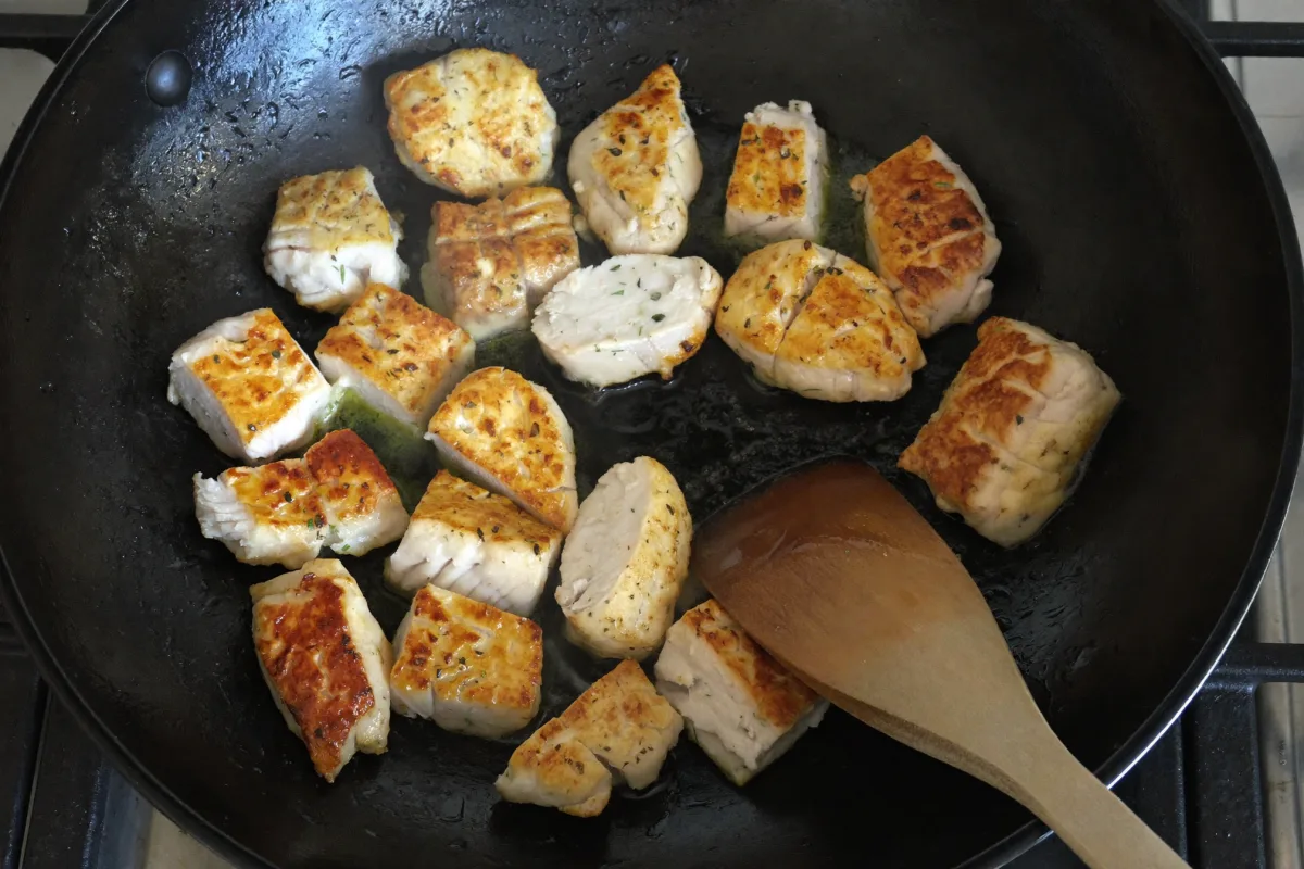 Chicken pieces searing in a hot wok for a high protein stir fry