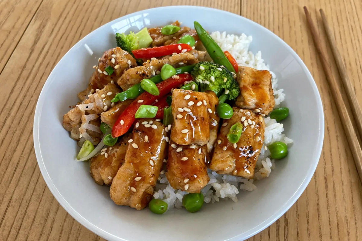 High protein chicken stir fry served in a bowl over jasmine rice